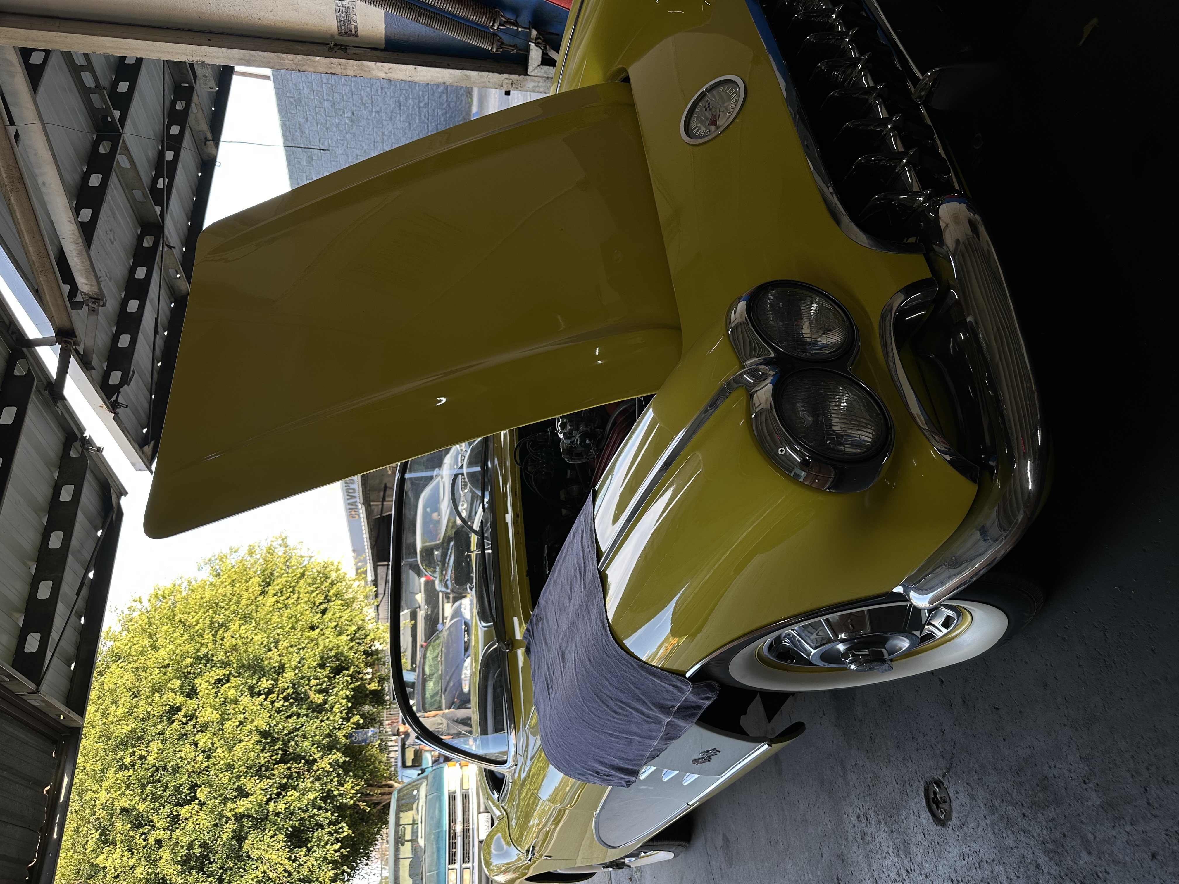 Yellow classic Corvette with hood up at Alamilla's Carburetors — Santa Ana, CA